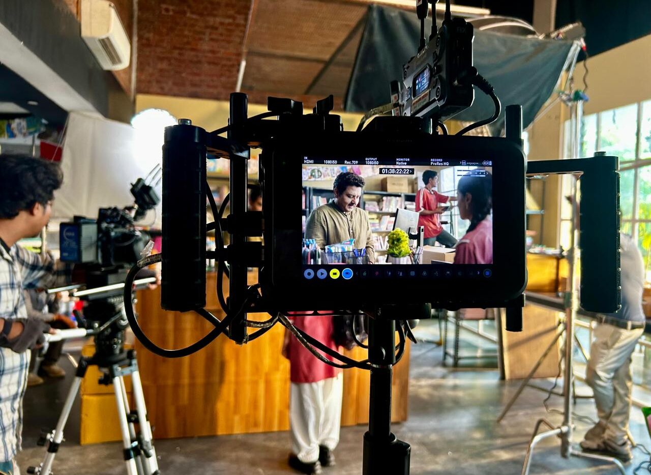 Professional ad shoot set with camera, lighting and production crew